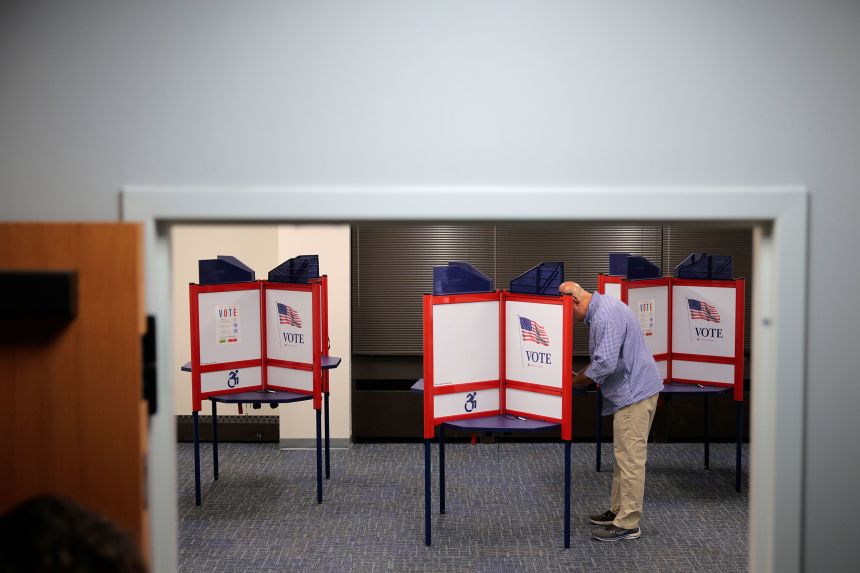 A voter cast their ballot on the first day of early voting at the Western Government Center in Henrico, Virginia, on September 19.