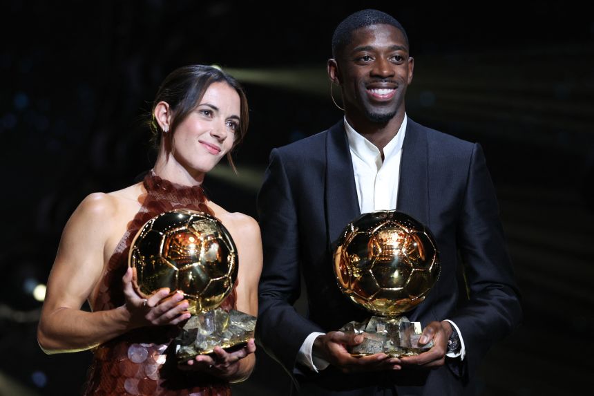 Aitana Bonmatí and Ousmane Dembélé pose together with their Ballon d'Or trophies on Monday.