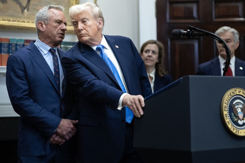 Health and Human Services Secretary Robert F. Kennedy Jr. speaks quietly to President Donald Trump