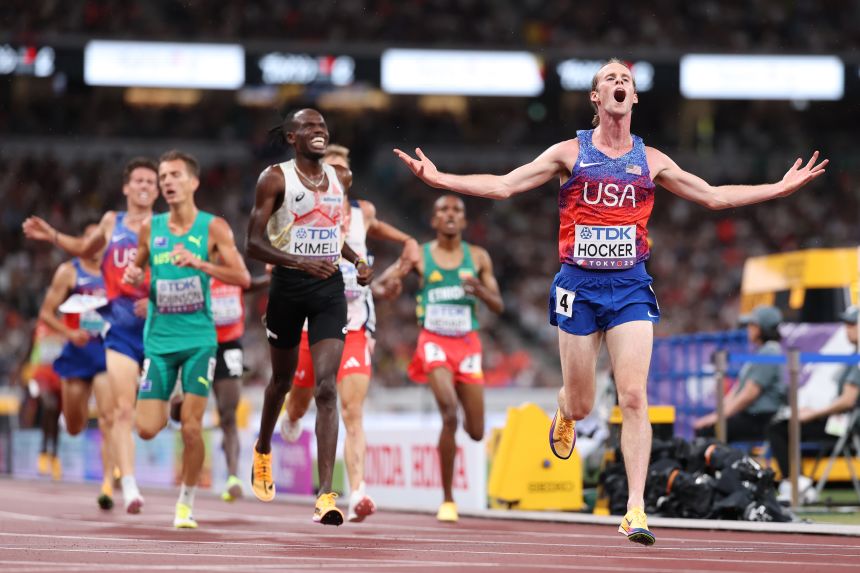 Cole Hocker celebrates after crossing the finish line to win gold in the men's 5000m.