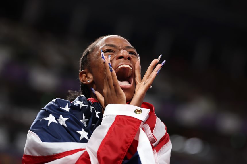 Melissa Jefferson-Wooden celebrates gold in the Women's 4x100m relay of the World Athletics Championships.