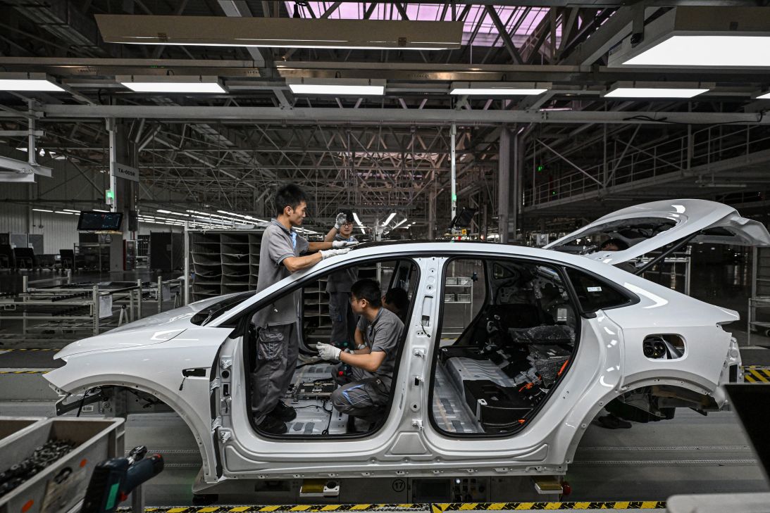 Employees work on an electric vehicle production line at a factory of Chinese automaker NIO in Hefei, on September 24. Employees work on an electric vehicle production line at a factory of Chinese automaker NIO in Hefei, on September 24.