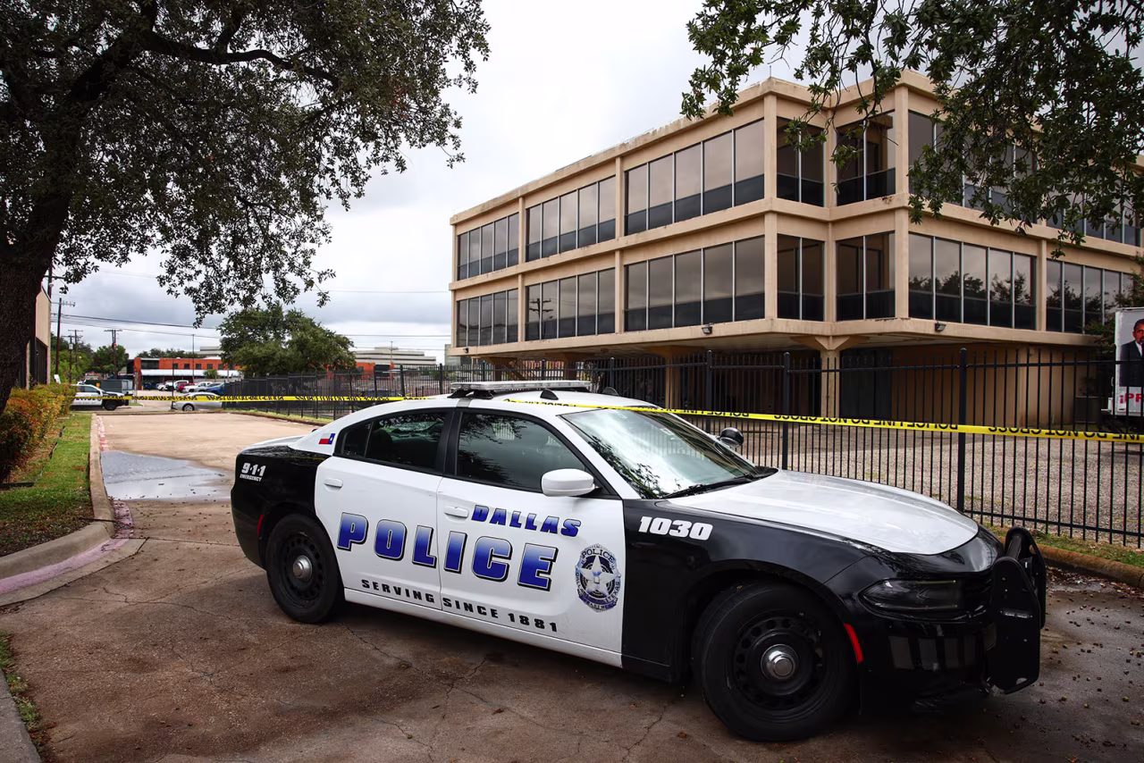 A Dallas Police Department vehicle sits near the scene of a shooting near a US Immigration and Customs Enforcement  detention facility in Dallas, Wednesday.