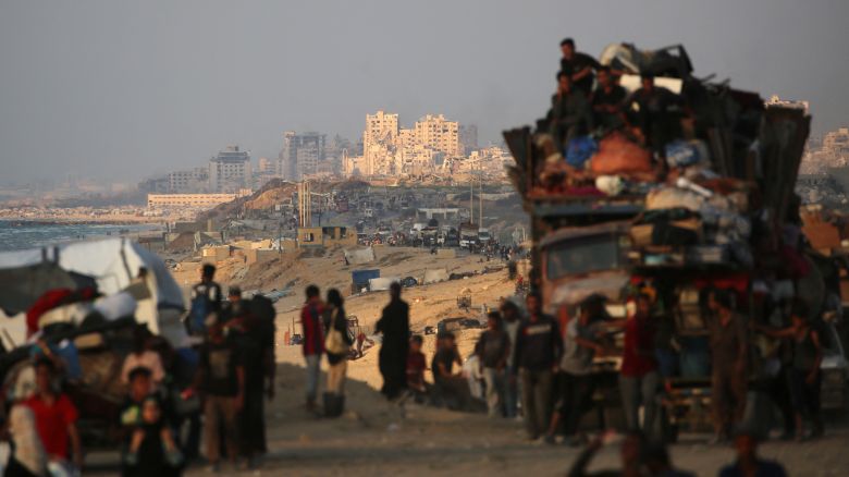 Displaced Palestinians move with their belongings southwards on a road in the Nuseirat refugee camp area in the central Gaza Strip.