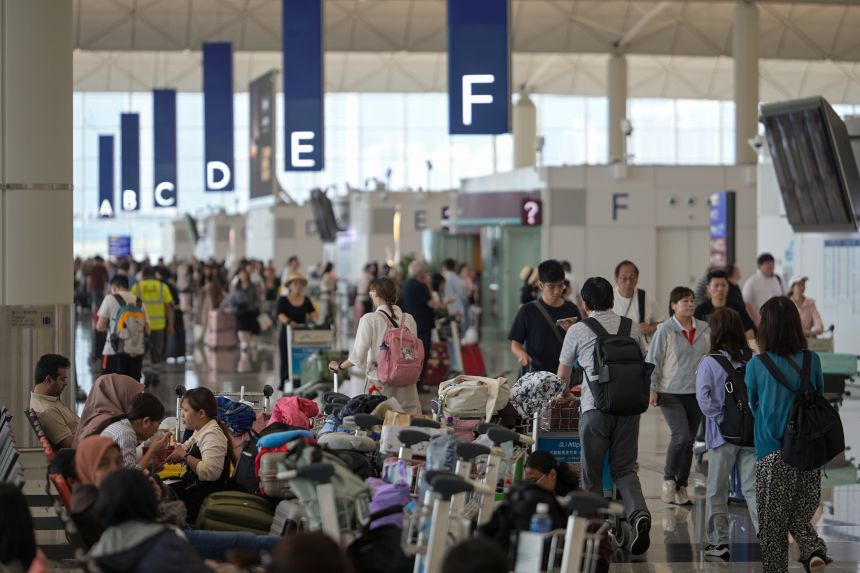 Passengers wait at Hong Kong International Airport.