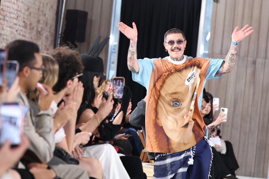 Adrian Appiolaza takes a bow at the end of the Moschino show.