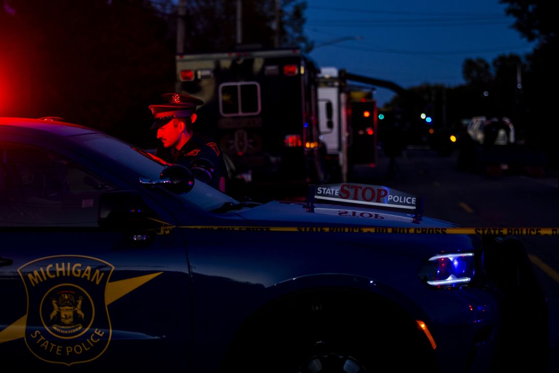 Michigan State Police patrol a street Sunday in Burton, Michigan.