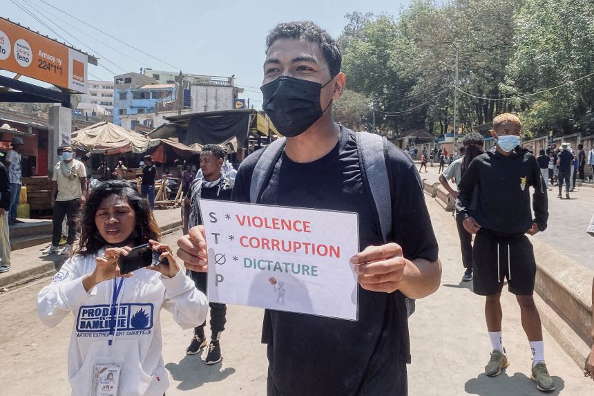 A protester holds a placard during a demonstration against repeated water and electricity outages in Antananarivo on Monday.
