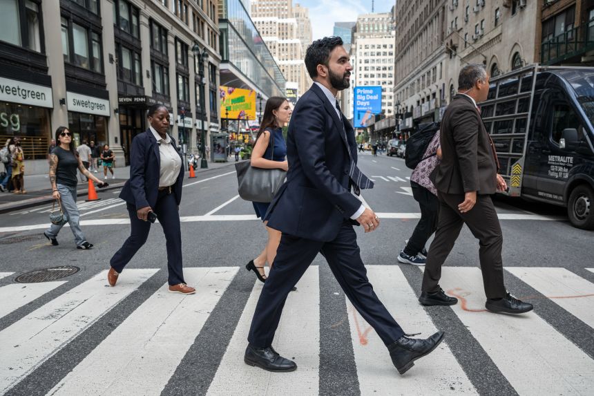 Zohran Mamdani, center, walks through midtown Manhattan, New York, on September 29.