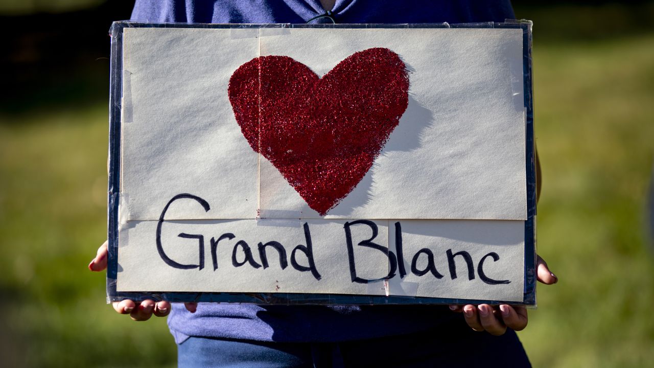 Nurses who are on strike hold signs in support of the community following a shooting and fire at the Church of Jesus Christ of Latter-day Saints in front of Henry Ford Genesys Hospital on September 29, 2025 in Grand Blanc, Michigan. The suspect crashed his vehicle into the church on the morning of September 28, started shooting and set the church on fire. At least four people were killed and eight wounded. The gunman was killed by police.
