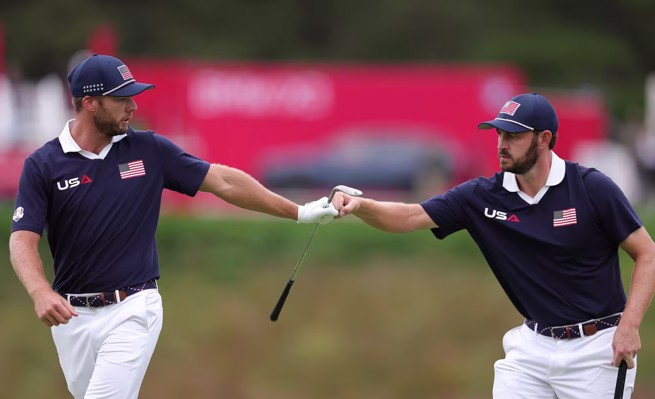 Sam Burns and Patrick Cantlay celebrate winning the 14th hole.