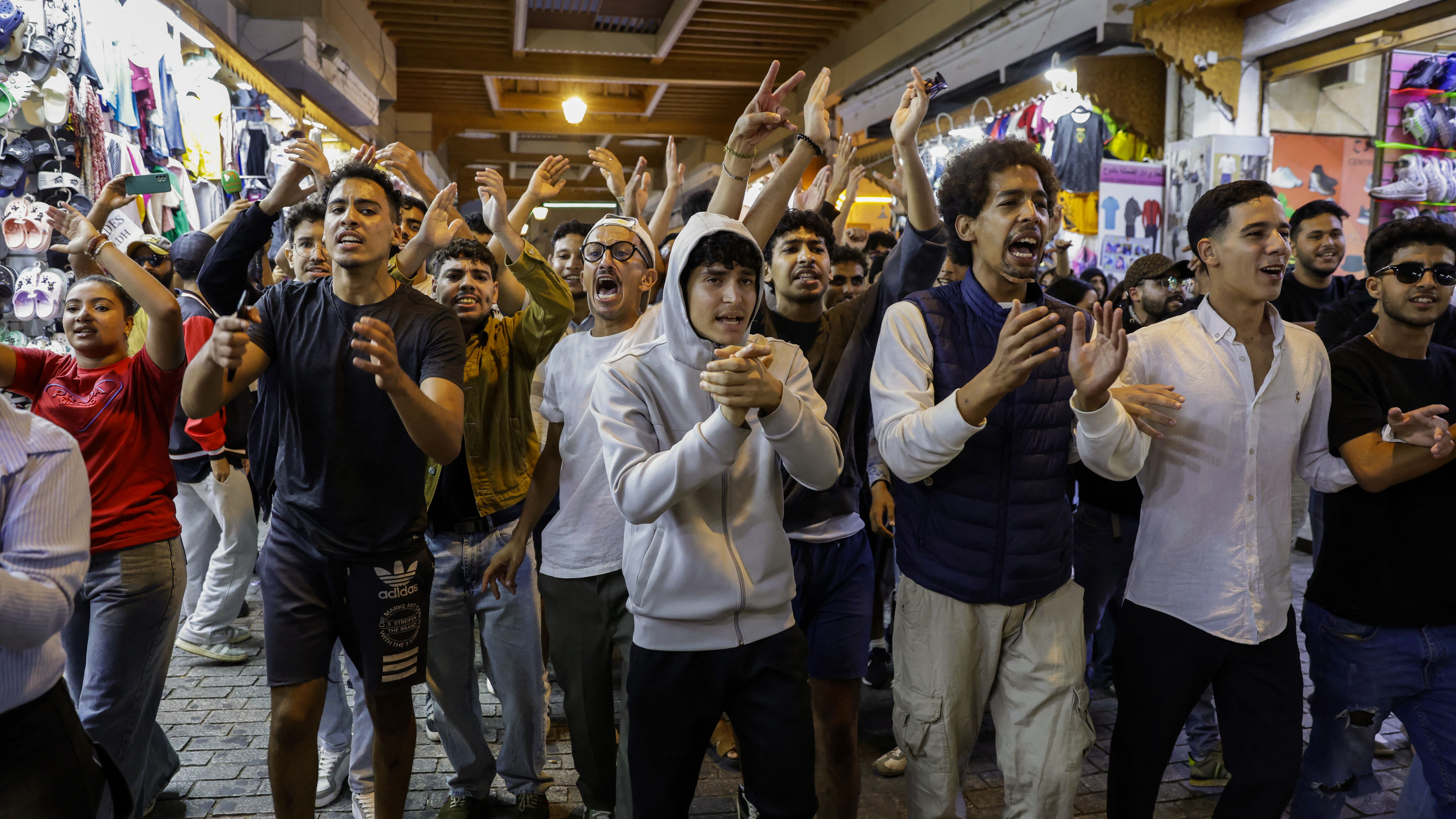 TOPSHOT - Protesters shout slogans during a youth-led demonstration in a market area in Rabat on September 29, 2025, calling for reforms in the public health and education sectors. Dozens of youths were detained on September 29 in Morocco on the third day of protests calling for education and public health reforms, according to a local rights group and AFP reporters.