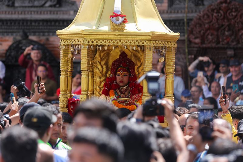 Trishna Shakya, the retired Royal Kumari of Kathmandu, is carried back to her home in a palanquin amid a ceremony in Kathmandu, Nepal.