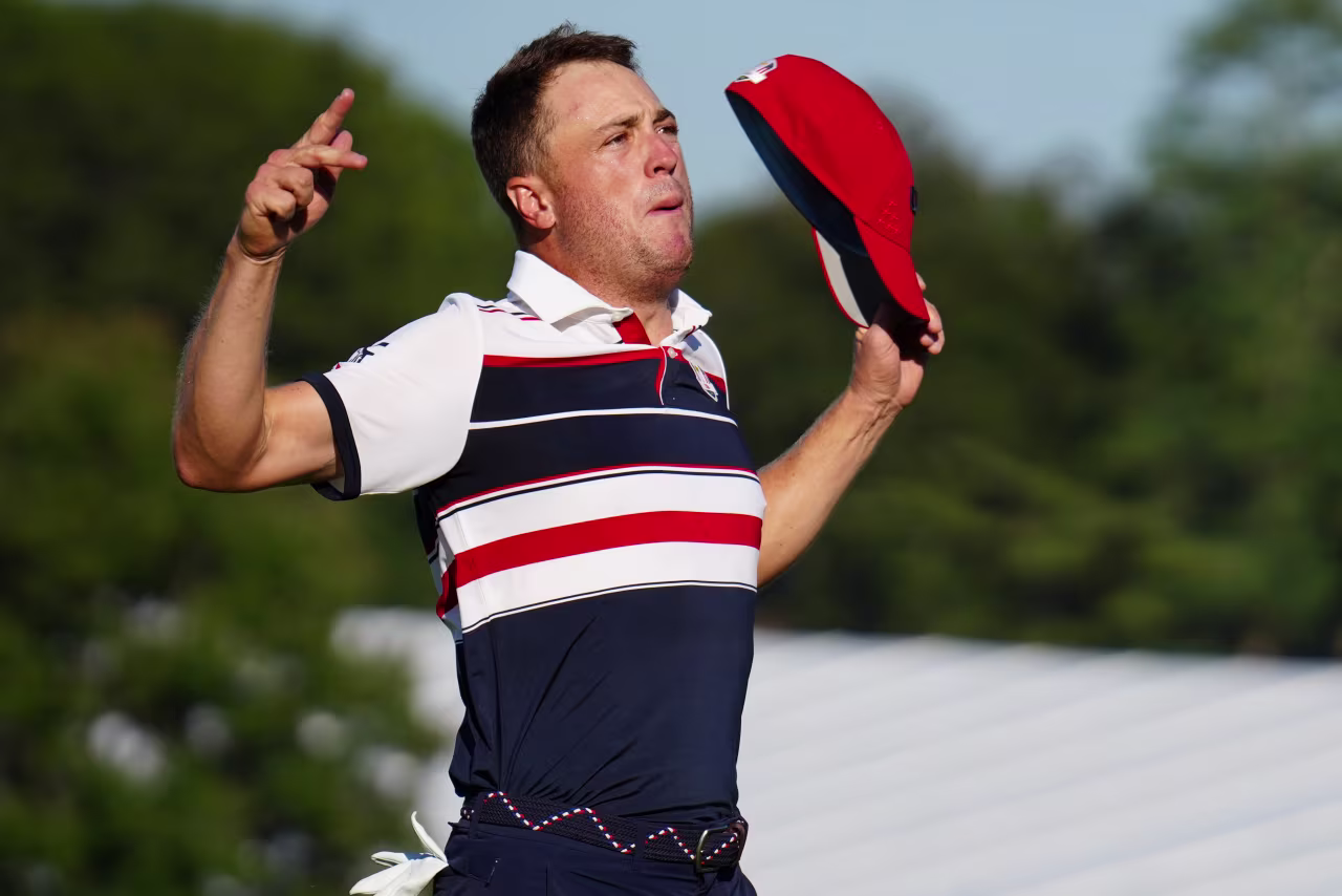 Justin Thomas celebrates after defeating Tommy Fleetwood with a birdie putt on No. 18.