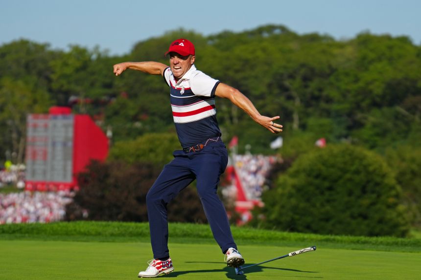 Justin Thomas celebrates on the 18th green after sinking a putt to defeat Tommy Fleetwood at the Ryder Cup on Sunday.