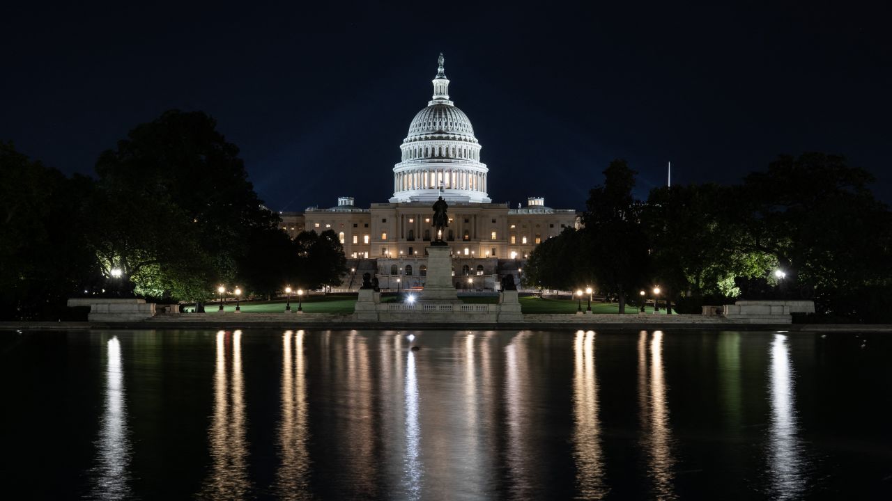 The US Capitol is seen lit up hours before a partial government shutdown is set to take effect in Washington, DC, on September 30, 2025.
