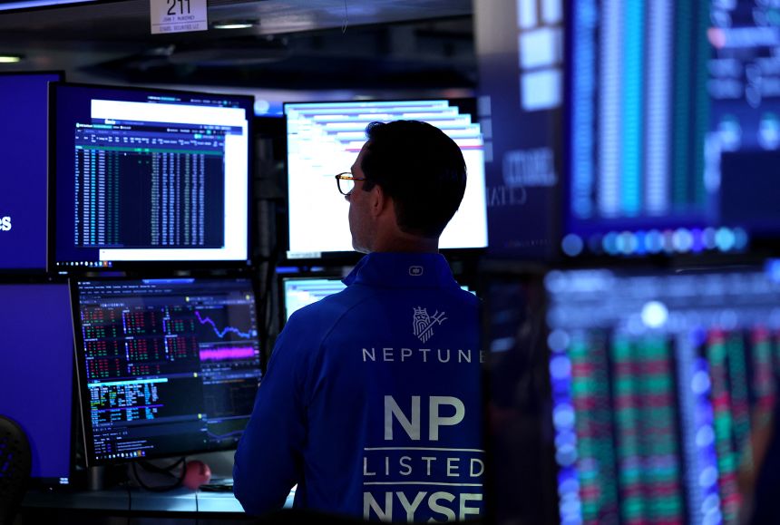 A trader works on the floor of the New York Stock Exchange at the opening bell on October 1.