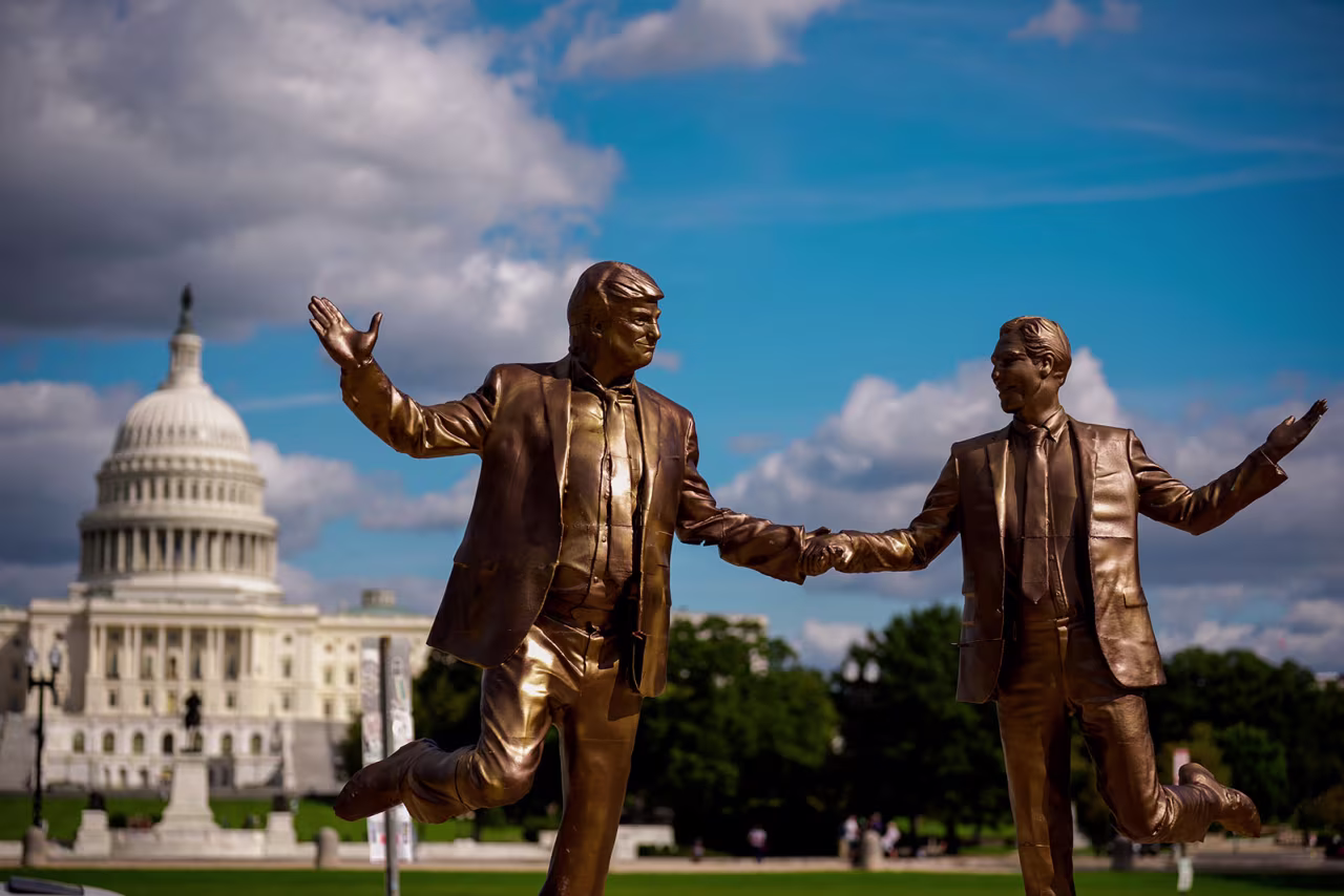 The Dome of the US Capitol Building is visible behind a statue depicting President Donald Trump and Jeffrey Epstein holding hands, placed on the National Mall on Thursday, in Washington, DC. T