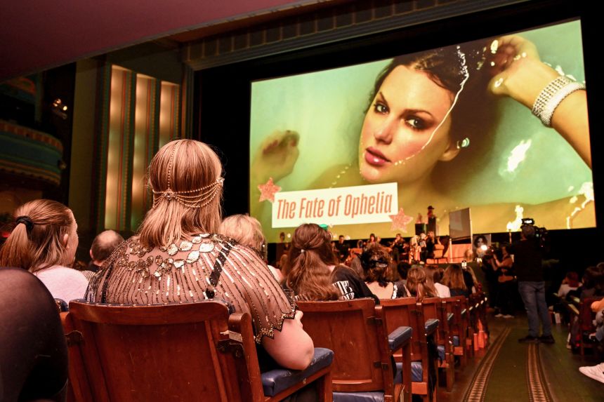 Taylor Swift fans listen to a song during a listening event for Swift's new album 'The Life of a Showgirl' at the Astor Theatre in Melbourne, on October 3, 2025.