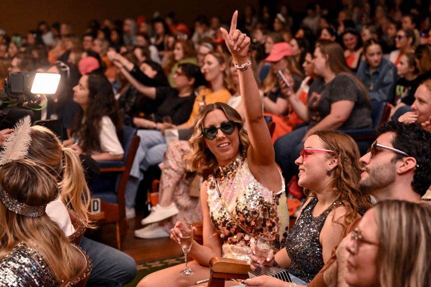 Taylor Swift fans react during a listening event for Swift's new album 'The Life of a Showgirl' at the Astor Theatre in Melbourne, on October 3, 2025.