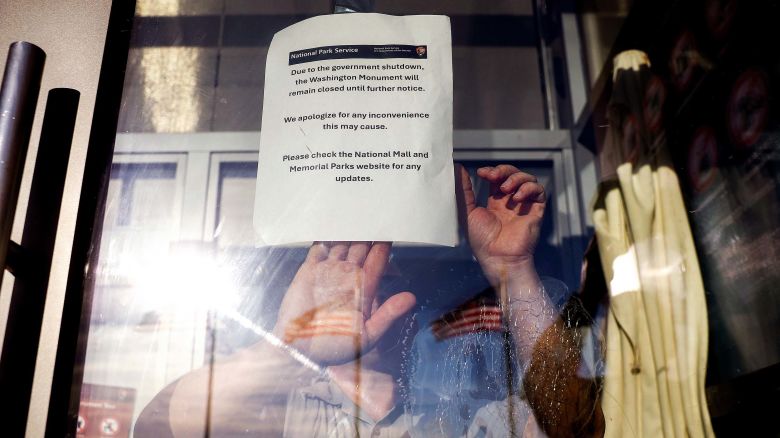 A member of the U.S. Park Service puts up a closed sign at the Washington Monument on October 01, 2025 in Washington, DC.