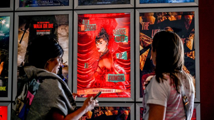 Fans take pictures in the lobby as they attend "Taylor Swift: The Official Release Party of a Showgirl" at AMC Montgomery 16 movie theater in Bethesda, Maryland on October 3, 2025. To go alongside the 12-track album -- already the most streamed release of 2025 -- fans in dozens of countries are packing theaters for an accompanying film that is being released for three days only.
"Taylor Swift: The Official Release Party of a Showgirl" offers personal commentary from the singer as well as a first look at the video for the album's opening track, "The Fate of Ophelia." (Photo by Alex WROBLEWSKI / AFP) (Photo by ALEX WROBLEWSKI/AFP via Getty Images)          
