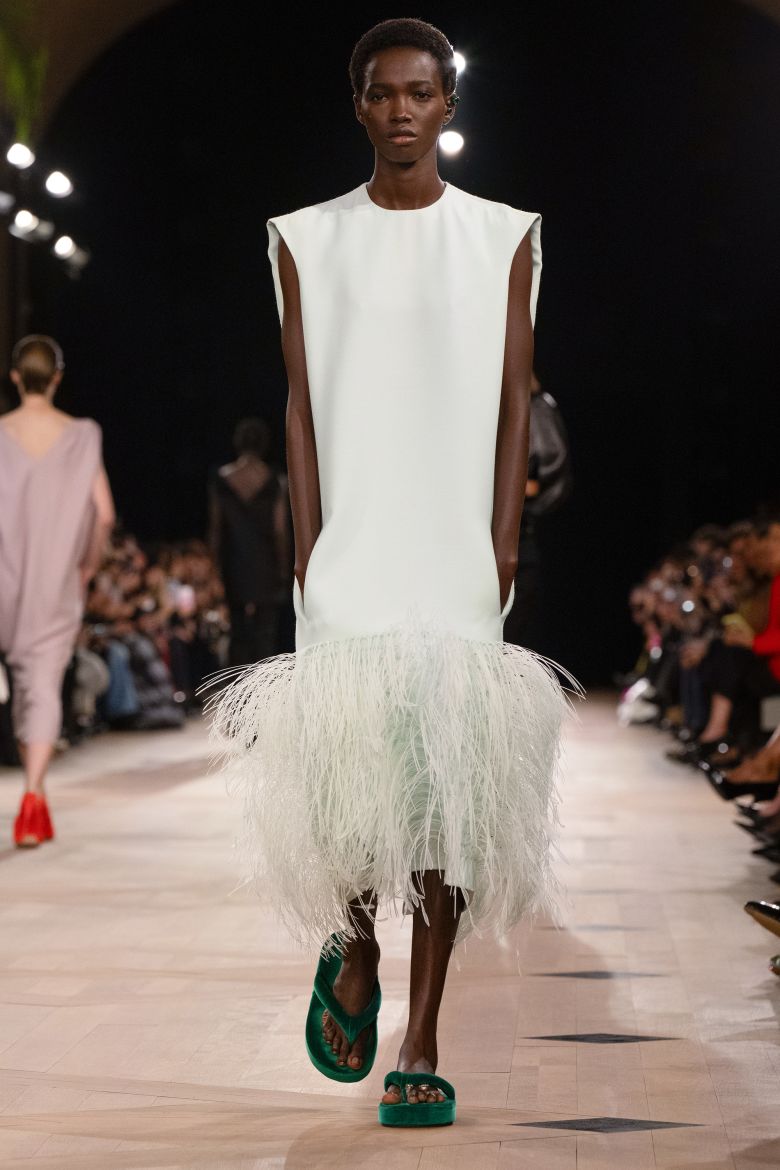 Unlike the Balenciaga model who wore the feathered dress with flat green shoes, Watts styled hers with classic black heels.