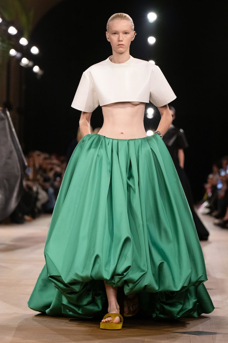 Styled by Karla Welch, Paulson wore look 50 — a white top with a high crop and a voluminous green skirt — from the Spring 2026 runway.