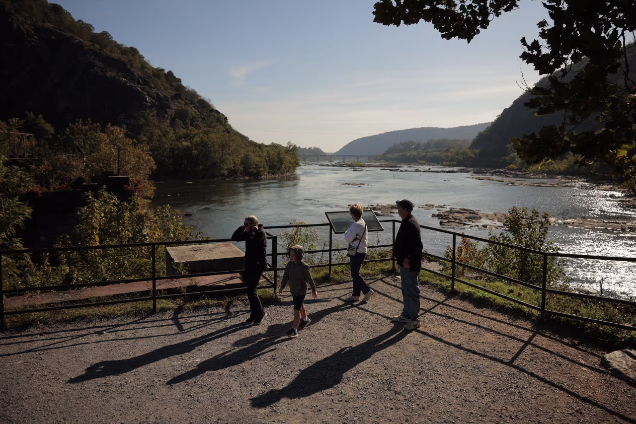 Visitors look at the confluence of the Potomac and Shenandoah rivers in the Harpers Ferry National Historical Park Lower Town in Harpers Ferry, West Virginia on Thursday.