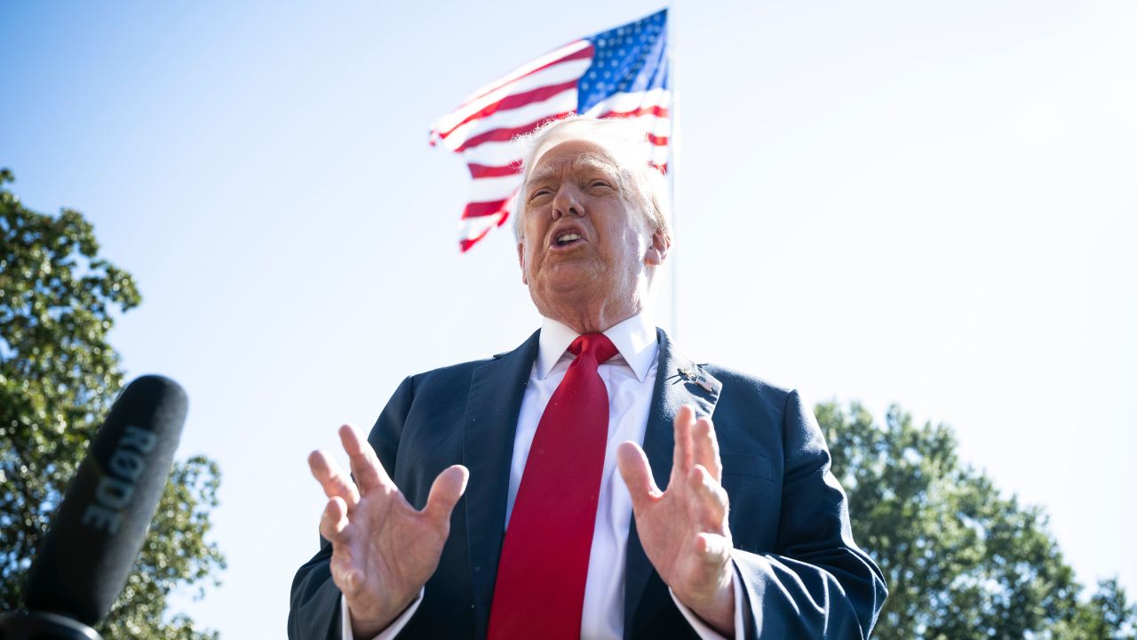 US President Donald Trump speaks to members of the media on the South Lawn of the White House before boarding Marine One in Washington, DC, on Sunday, October 5, 2025.