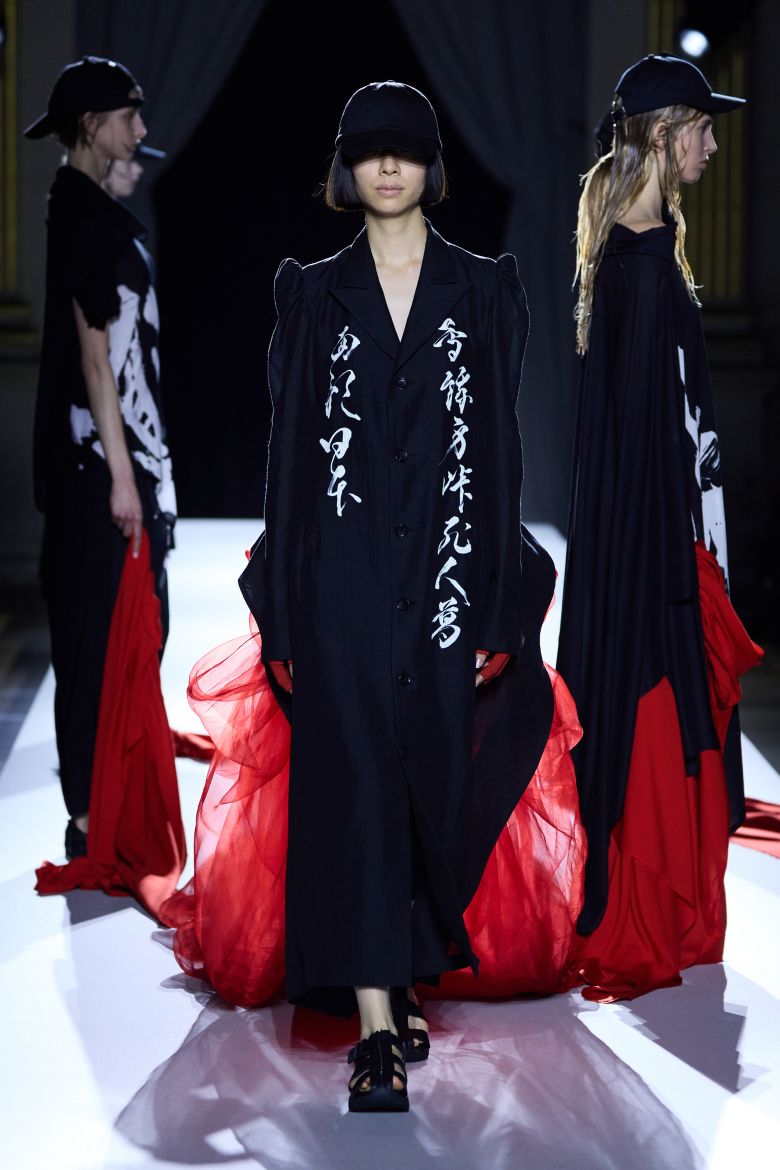 ... as well as many of his signature asymmetrical or draped shapes. Japanese calligraphy, which was also printed on the show invitation, featured on some garments.