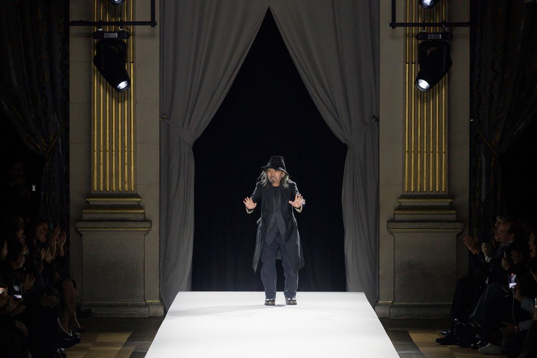 The eponymous designer Yohji Yamamoto tipped his hat and then waved to guests as he took a bow at the end of his show.