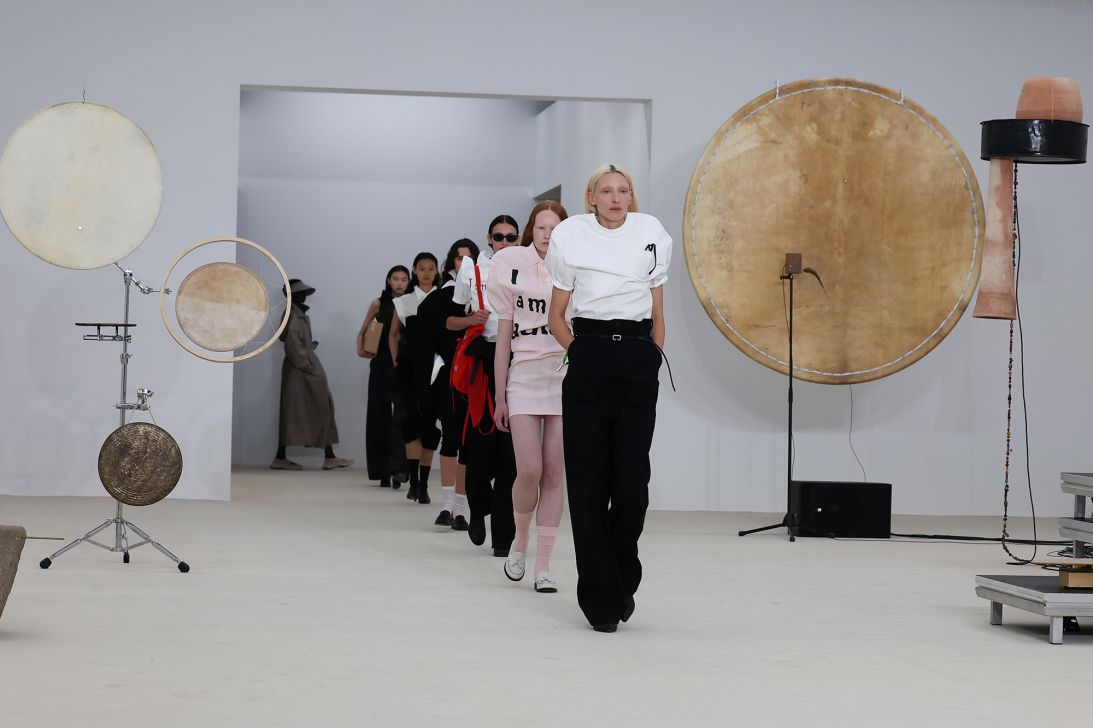 Model Maggie Maurer leads the runway for the Issey Miyake Spring-Summer 2026 show. The shrunken top she wore created the illusion of high, rounded shoulders.