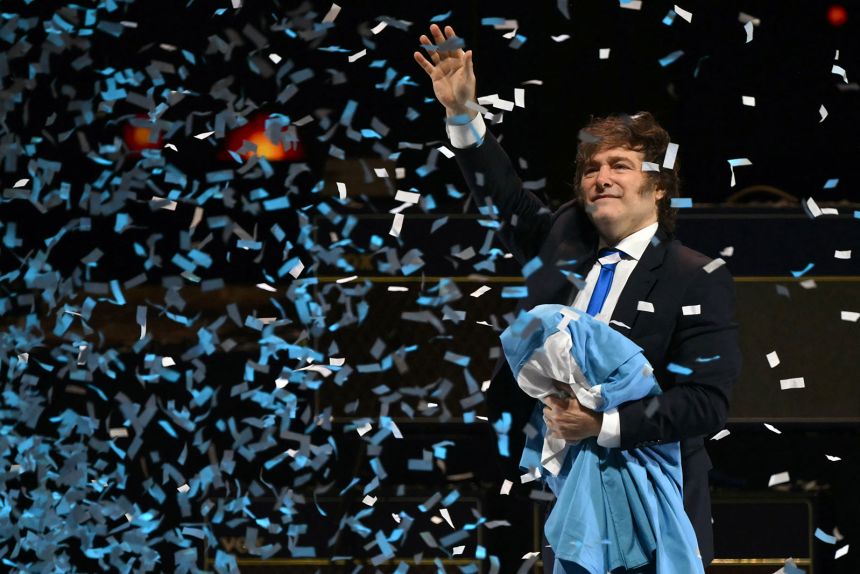 Argentina's President Javier Milei waves to supporters during the launch of his new book, 