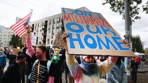 Protesters gather outside of a downtown U.S. Immigration and Customs Enforcement (ICE) facility on October 04, 2025 in Portland, Oregon. The facility has become a focal point of nightly protests against the Trump administration and his announcement that he will be sending National Guard troops into Portland.