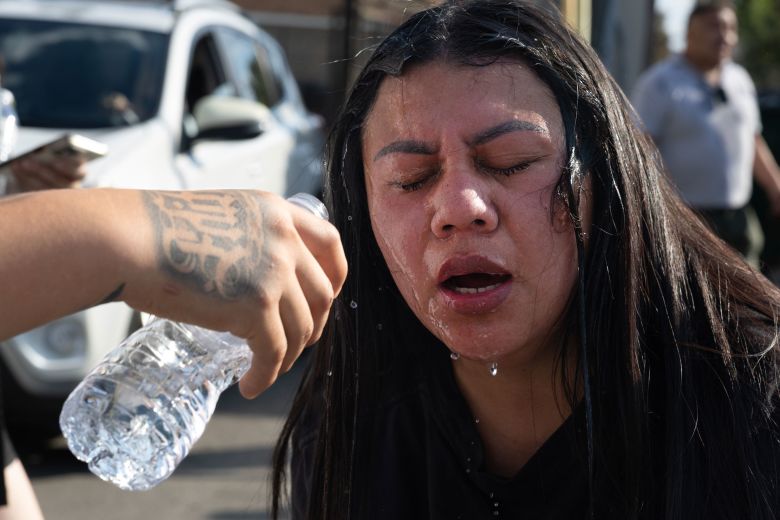 A woman is treated for exposure to tear gas after it was used by federal law enforcement agents in Brighton Park, on the southwest side of Chicago, on Saturday.