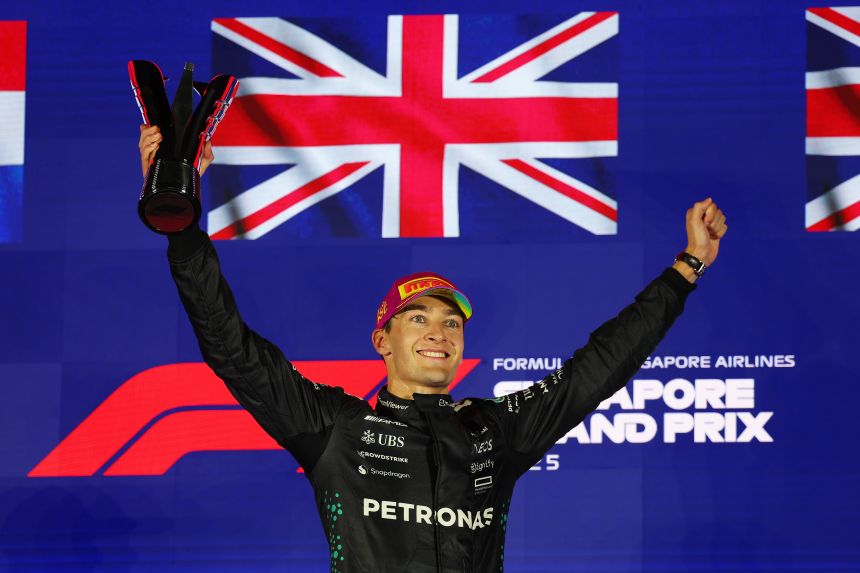 George Russell of Great Britain celebrate on the podium during the F1 Grand Prix of Singapore at Marina Bay Street Circuit.