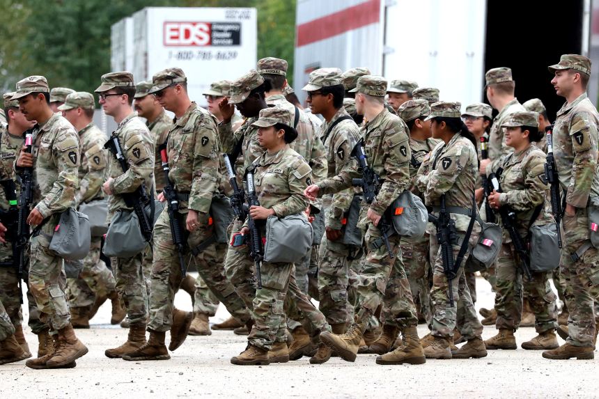 Members of the Texas National Guard assemble at the Army Reserve Training Center in Elwood, Illinois,  on October 7.