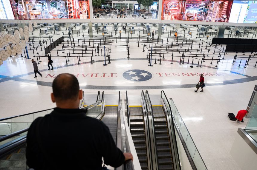 Travelers make their way to the gates during a temporary ground stop at the Nashville International Airport on October 7, 2025 in Nashville, Tennessee.