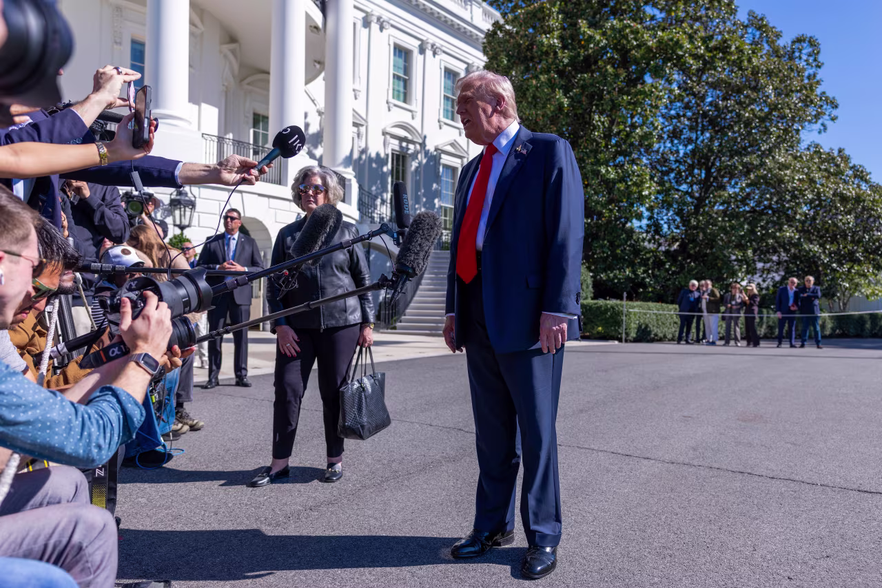 President Donald Trump talks to the media before heading to Marine One on the south lawn of the White House today.