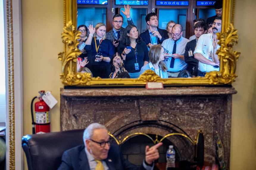 Senate Minority Leader Chuck Schumer takes a question during a