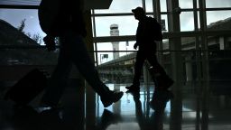 People walk through Reagan National Airport in Arlington, Virginia, on October 8, 2025.