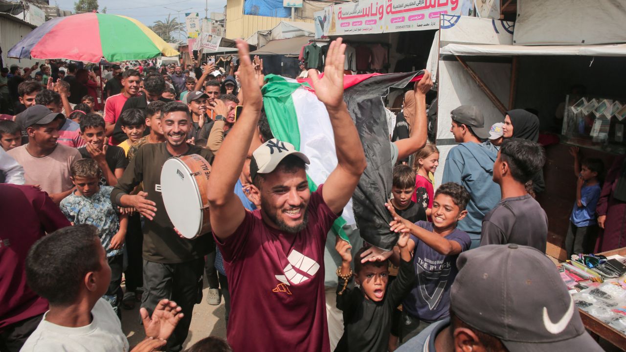 Palestinians celebrate in Al-Mawasi, Rafah, Gaza Strip, on October 9, 2025, following news of a new Gaza ceasefire deal. Israel and Hamas agree on October 9 to a Gaza ceasefire and hostage deal after two years of war in Gaza. (Photo by Abdelrahman Rashad / Middle East Images via AFP) (Photo by ABDELRAHMAN RASHAD/Middle East Images/AFP via Getty Images)          