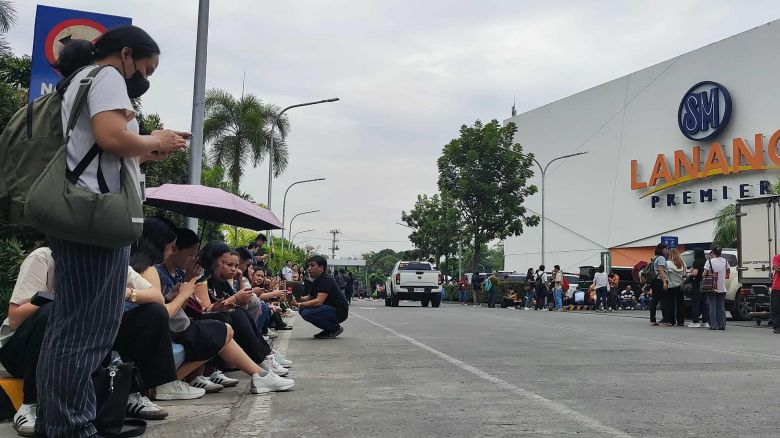Employees at a shopping mall gather outside the building in Davao City, on the southern island of Mindanao on October 10, 2025, after a 7.4-magnitude earthquake struck off the southern Philippines. A powerful magnitude-7.4 earthquake struck off the southern Philippines on October 10, triggering warnings of a "destructive tsunami" on the country's Pacific coast within hours.