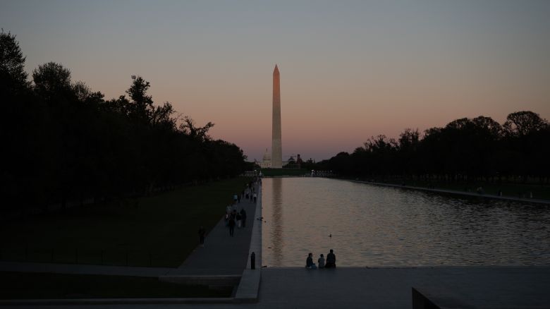 People visit the National Mall during a government shutdown in Washington, DC, on October 9, 2025.
