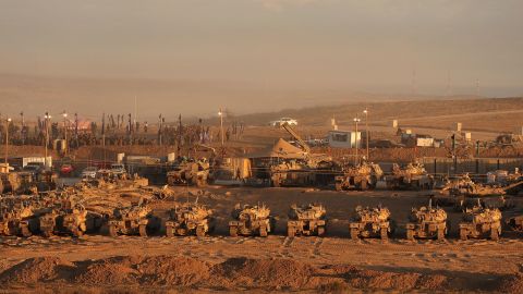TOPSHOT - Israeli troops gather at a position along the Israel-Gaza border fence on October 10, 2025. Gaza's civil defence agency said October 10 that Israeli forces have begun pulling back from parts of the territory, particularly in Gaza City and Khan Yunis. Israeli prime minister's office said that the government had "approved the framework" of a hostage release deal with Hamas, as both sides edged closer to ending more than two years of hostilities in Gaza. (Photo by Jack GUEZ / AFP) (Photo by JACK GUEZ/AFP via Getty Images)          