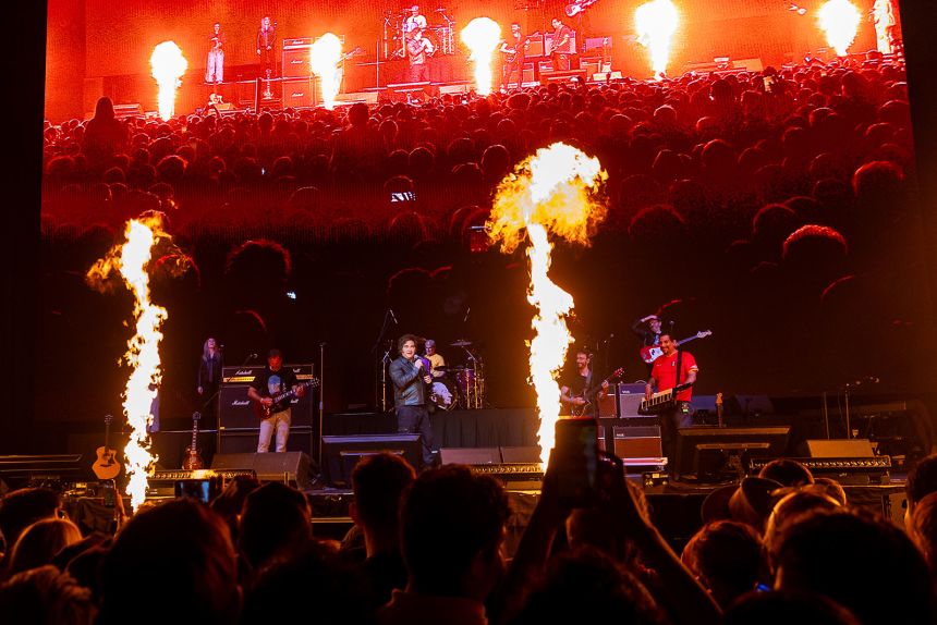 Argentine President Javier Milei sings in a show with a band during the presentation of his book 'La Construccion del Milagro' at Movistar Arena on October 6, 2025, in Buenos Aires, Argentina.