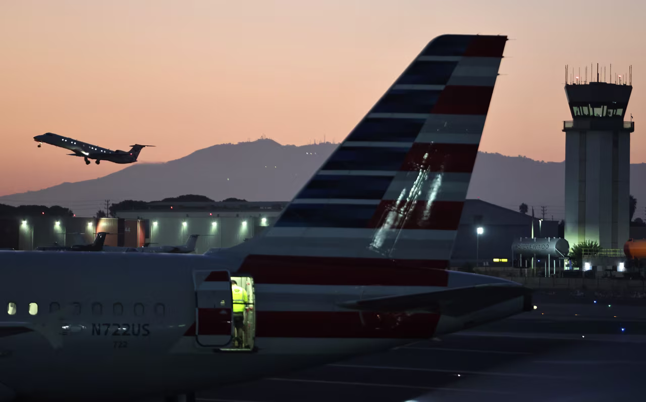 A plane takes off near the Hollywood Burbank Airport air traffic control tower in Burbank, California, on October 6.
