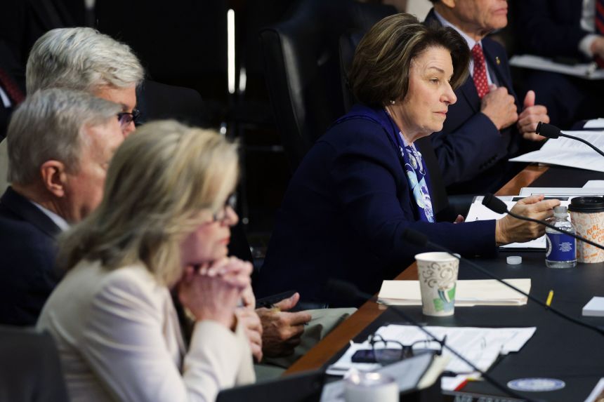Sen. Amy Klobuchar looks on as Attorney General Pam Bondi testifies.