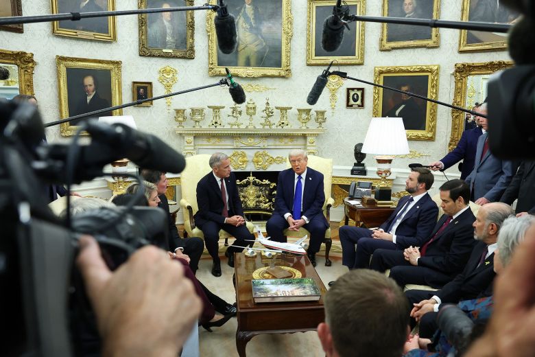 U.S. President Donald Trump (C-R) speaks to reporters alongside Canadian Prime Minister Mark Carney (C-L) in the Oval Office of the White House on October 7, 2025 in Washington, DC.
